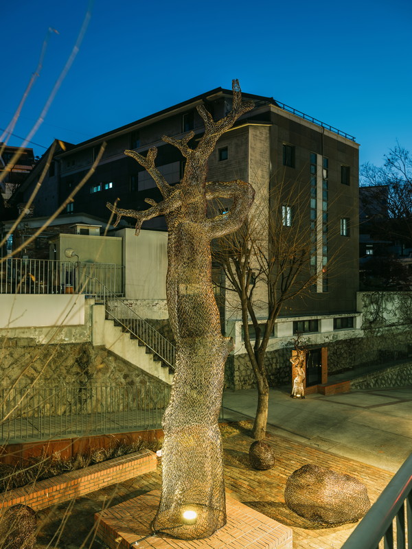 이길래 '생이 깃든 소나무', 2025년, 동파이프 산소용접, 650(h)x105x113cm, 돌 4점 포함(개별 사이즈). ※ 본 작품은 이길래 외 그의 두 딸이자 조각가인 故이다빈(이뭉)과 이어진이 함께 작업에 참여하였다. (출처=성북구립미술관)