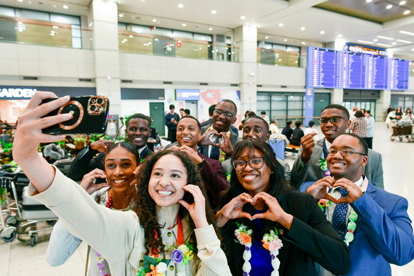 82차 해외성도방문단으로 방한한 미국, 캐나다, 멕시코 등지 하나님의 교회 신자들이 인천국제공항으로 입국했다. 한국 신자들이 걸어준 사탕목걸이를 하고 사진을 찍고 있다. (사진제공=하나님의교회)